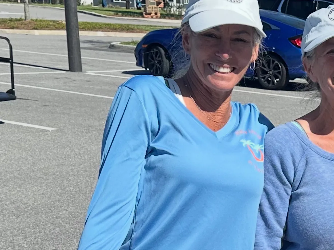 Villages Healthy Living long-sleeve V-neck tee in light blue with the palm tree logo